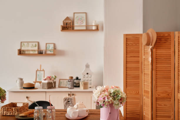 istock White kitchen interior in loft style. Shelves with pink crockery and kitchen utensils. Studio apartment. Rent and delivery of housing. Hostel and hotel 1420347879