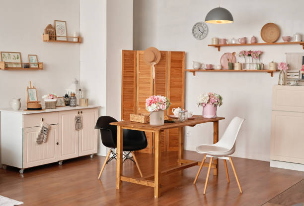 istock White kitchen interior in loft style. Shelves with pink crockery and kitchen utensils. Studio apartment. Rent and delivery of housing. Hostel and hotel 1420347883