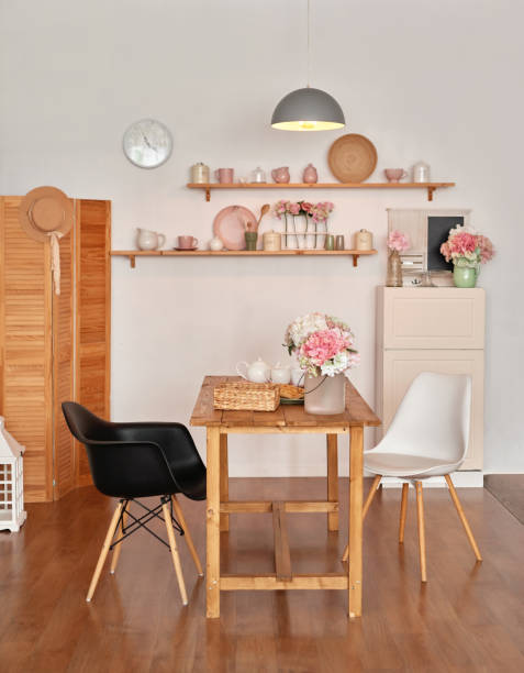 istock White kitchen interior in loft style. Shelves with pink crockery and kitchen utensils. Studio apartment. Rent and delivery of housing. Hostel and hotel 1420347914