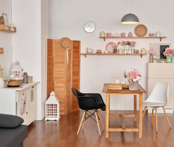 istock White kitchen interior in loft style. Shelves with pink crockery and kitchen utensils. Studio apartment. Rent and delivery of housing. Hostel and hotel 1420348048