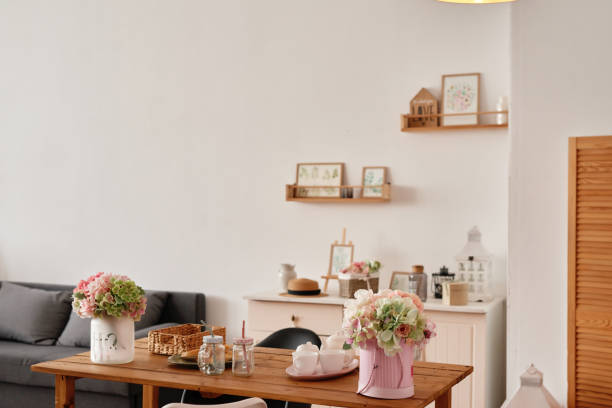 istock White kitchen interior in loft style. Shelves with pink crockery and kitchen utensils. Studio apartment. Rent and delivery of housing. Hostel and hotel 1420348059