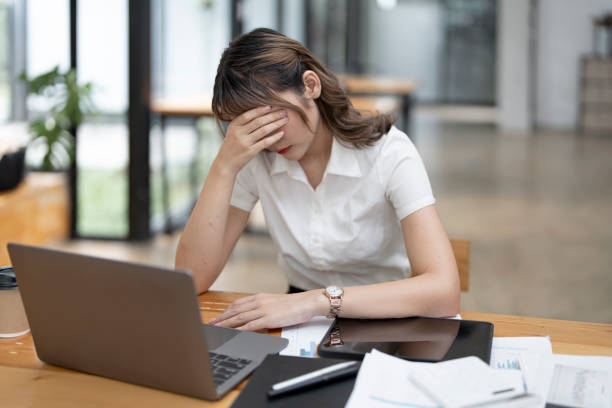 istock Tired asian business woman with headache at office, feeling sick at work, copy space 1420357814