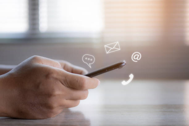istock Hand using smartphone with icon phone, chat message icon, mail, and address. 1420362207