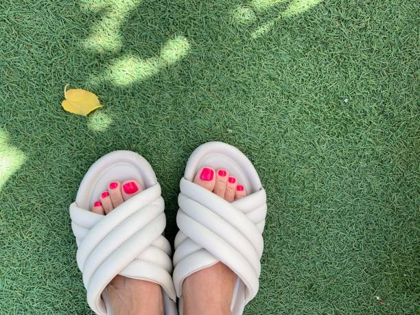 istock feet in flip flops on the grass 1420376894