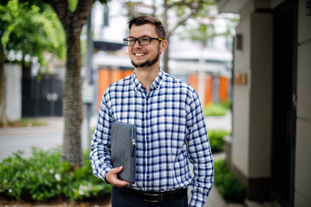 istock Handsome businessman standing in the street 1420386743