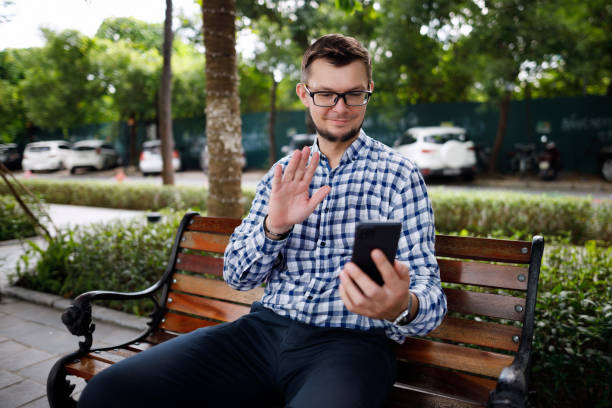 Handsome businessman  in plaid shirt having a video call stock photo