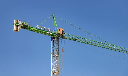 Gdansk, Poland - August 13, 2022: A picture of a Bauhaus crane against a blue sky.