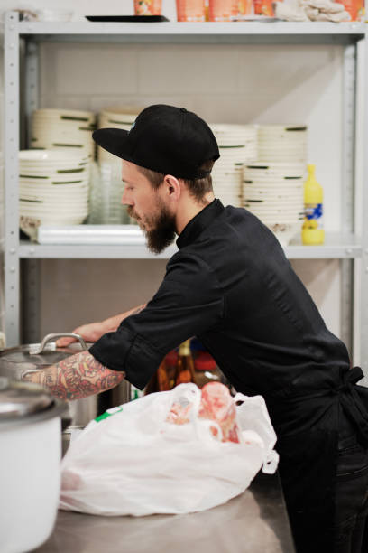 istock Chef busy at the kitchen with dishes 1420401879