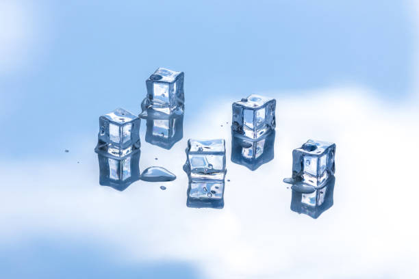 istock Melting ice cubes on reflective surface with sky in the background 1420413657