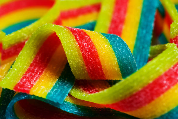 Rainbow sour jelly candies strips in sugar sprinkle.