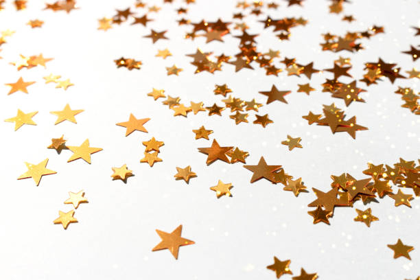 istock Glowing golden stars confetti scattered on a blue pastel background. 1420423482
