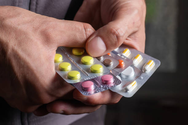 istock Man holding pack pills in blister. Pills packed 1420423682