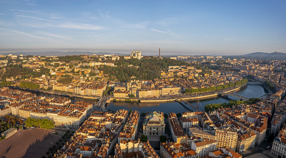 The drone panoramic view of The Basilica of Notre-Dame de Fourvière, Saone River and downtown district of Lyon at sunrise, France.