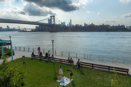 Brooklyn, NY, USA - August 28, 2022 -  A view of the three bridges along the East River as seen from Domino Park in Brooklyn NY