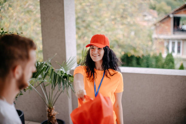 istock Woman delivery person 1420428480