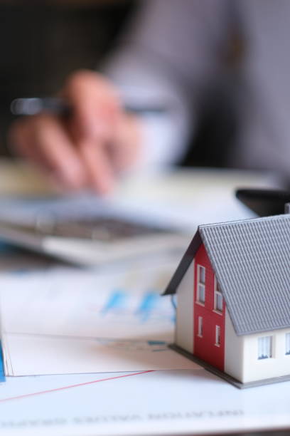 istock Real estate agent works in office 1420433356
