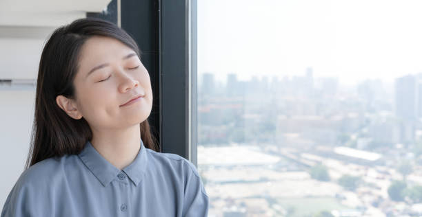 istock woman sitting by the window 1420438110