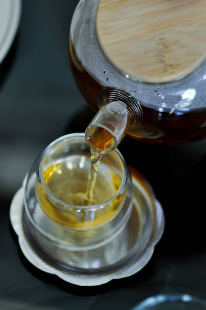 istock pouring tea , tea cup and tea pot 1420439612