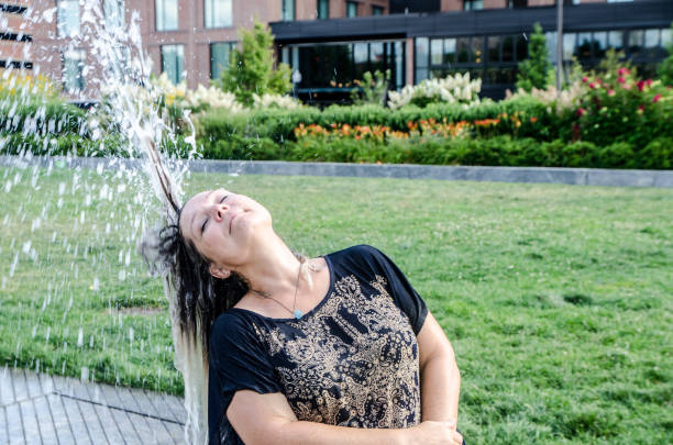 istock Woman refreshing herself with water jet 1420447963