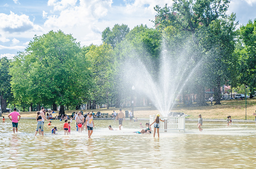 Boston Common Frog Pond crowded with people during heatwave on a summer day