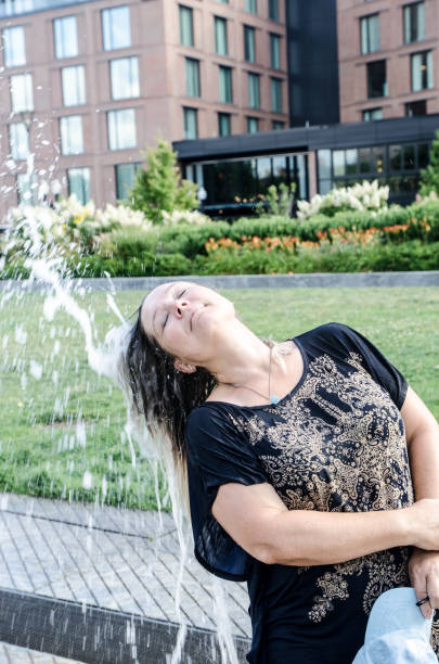 istock Woman refreshing herself with water jet 1420452439