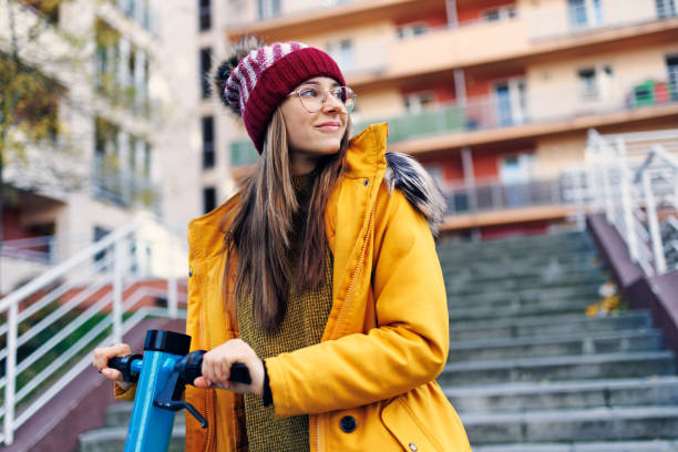 Teenage girl riding electric scooter. stock photo