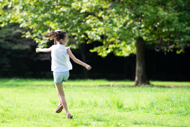 istock girl running in the park 1420460209