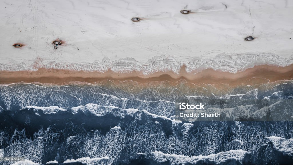 Boats on snowy beach in winter at Baltic Sea. Boats on snowy beach in winter at Baltic Sea. Aerial view of nature in winter. Arctic Stock Photo