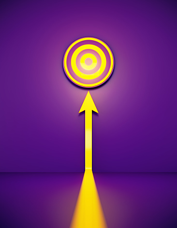 Yellow arrow and target glowing before purple background. Vertical composition with copy space.