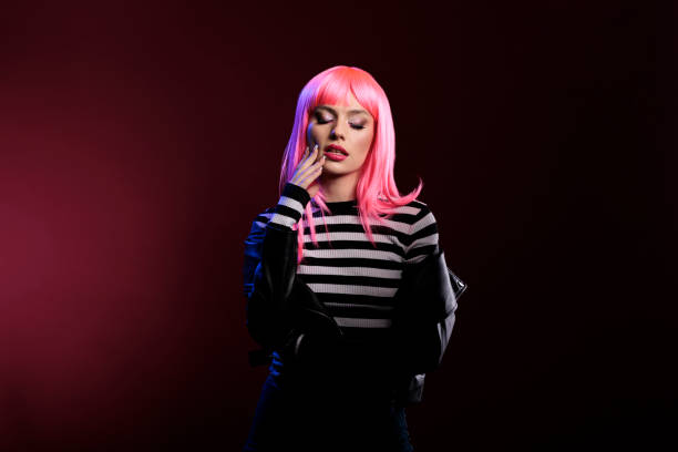 istock Beauty model with leather jacket standing in studio with dark shadows 1420470853