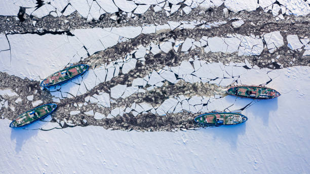 istock Four icebreakers crushing ice on river. Aerial view of winter. 1420471198