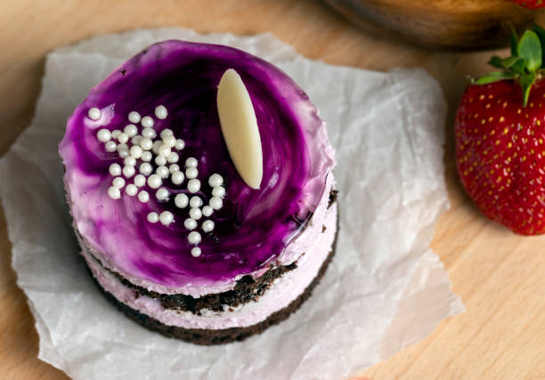 purple cake with berry flavor, sweet dessert cake with red strawberries