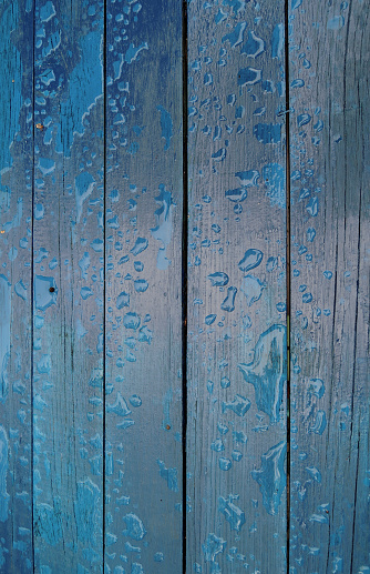 Wooden planks painted in loft style with water drops texture background