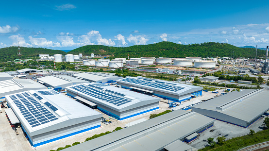 Top view Solar Cell on Warehouse Factory. Solor photo voltaic panels system power or Solar Cell on industrial building roof for producing green ecological electricity. Production of renewable energy.