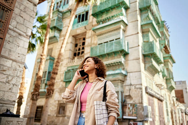 istock Woman walking in Al-Balad and conversing with caller 1420486877