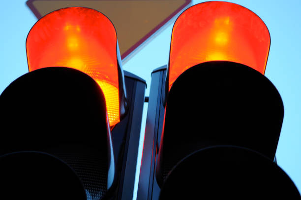 istock Close up of red traffic lights on blue sky background 1420491332