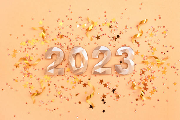 istock 2023 gold colored numbers, stars confetti and ribbons. 1420491966