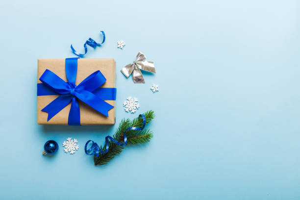 istock Top view Flat lay Christmas decorations and gift box on colored background with copy space. Christmas or Happy New Year composition 1420492230