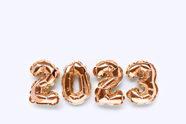 istock 2023 gold inflatable balloons on a blue pastel background with place for text. 1420494321