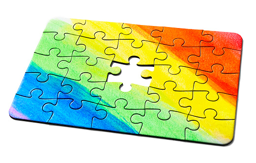 Jigsaw puzzle depicting a hand-painted spectrum needs the final piece as a solution.