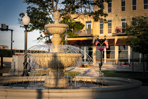 The morning sun warms a fountain in the downtown area of Manitowoc, Wisconsin.