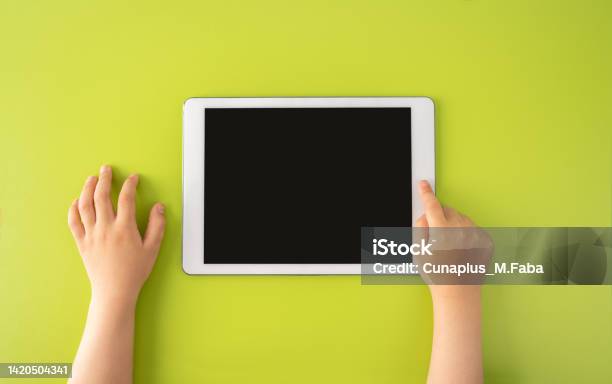 High Angle Shot Of A Little Kid Using A Digital Tablet Stock Photo - Download Image Now