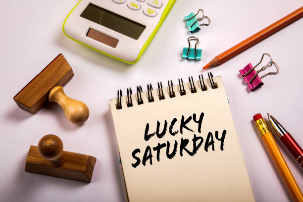 Lucky Saturday. Calculator, stamps and stationery on office table