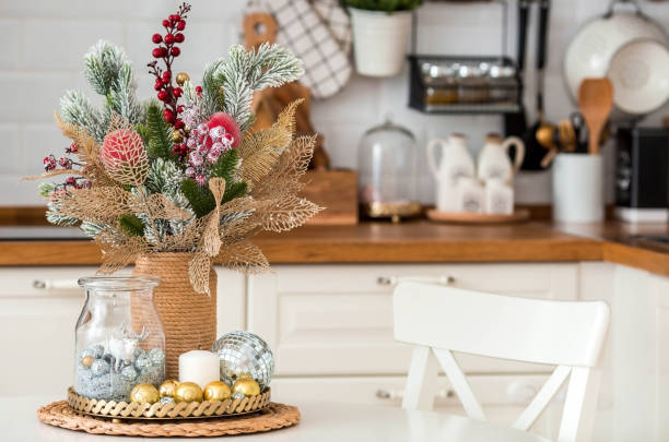 istock A spruce bouquet with red berries on a white kitchen table. Christmas decorations in the interior. The concept of preparing for the New year holiday. 1420506917