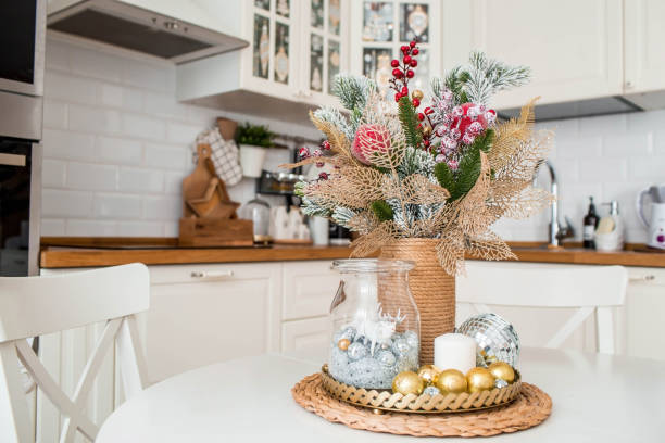 istock A spruce bouquet with red berries on a white kitchen table. Christmas decorations in the interior. The concept of preparing for the New year holiday. 1420506921