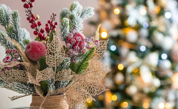 istock A spruce bouquet with red berries on a white kitchen table. Christmas decorations in the interior. The concept of preparing for the New year holiday. 1420506930
