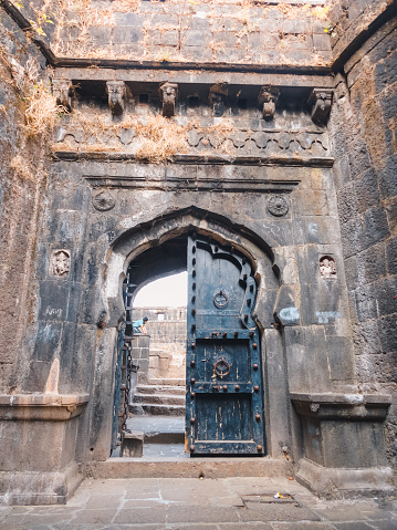Lohagad Fort Entrance Gate, Pune, India. The gate has a huge door made of wood in ancient times of Chatrapati Shivaji Maharaj, and the buildiung strucutre is made up of stone.