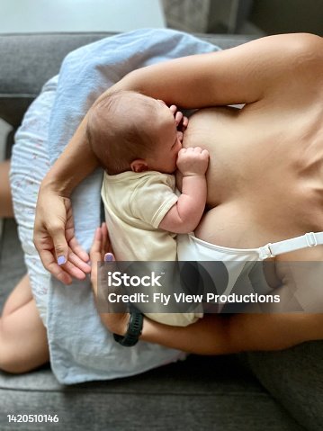 istock High angle view looking down of an infant happily nursing 1420510146