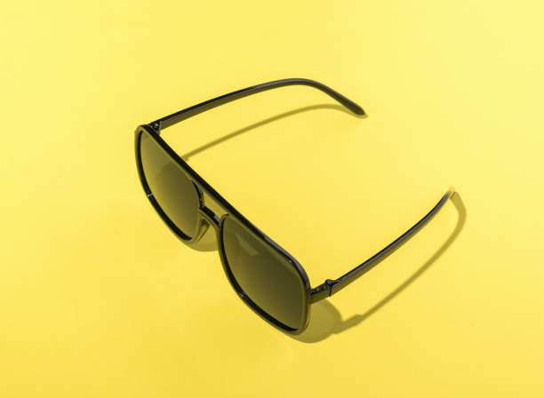 istock Large sunglasses on a bright yellow background. 1420515040