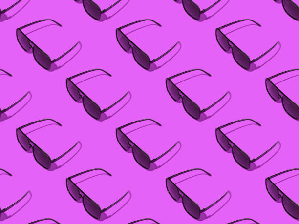 istock A pattern of beautiful sunglasses on a purple background. 1420515054